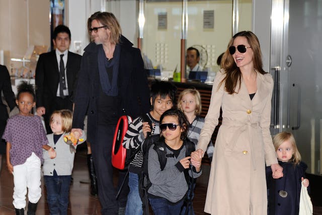 <p>Estranged couple Brad Pitt and Angelina Jolie photographed with their six children in 2011 </p>