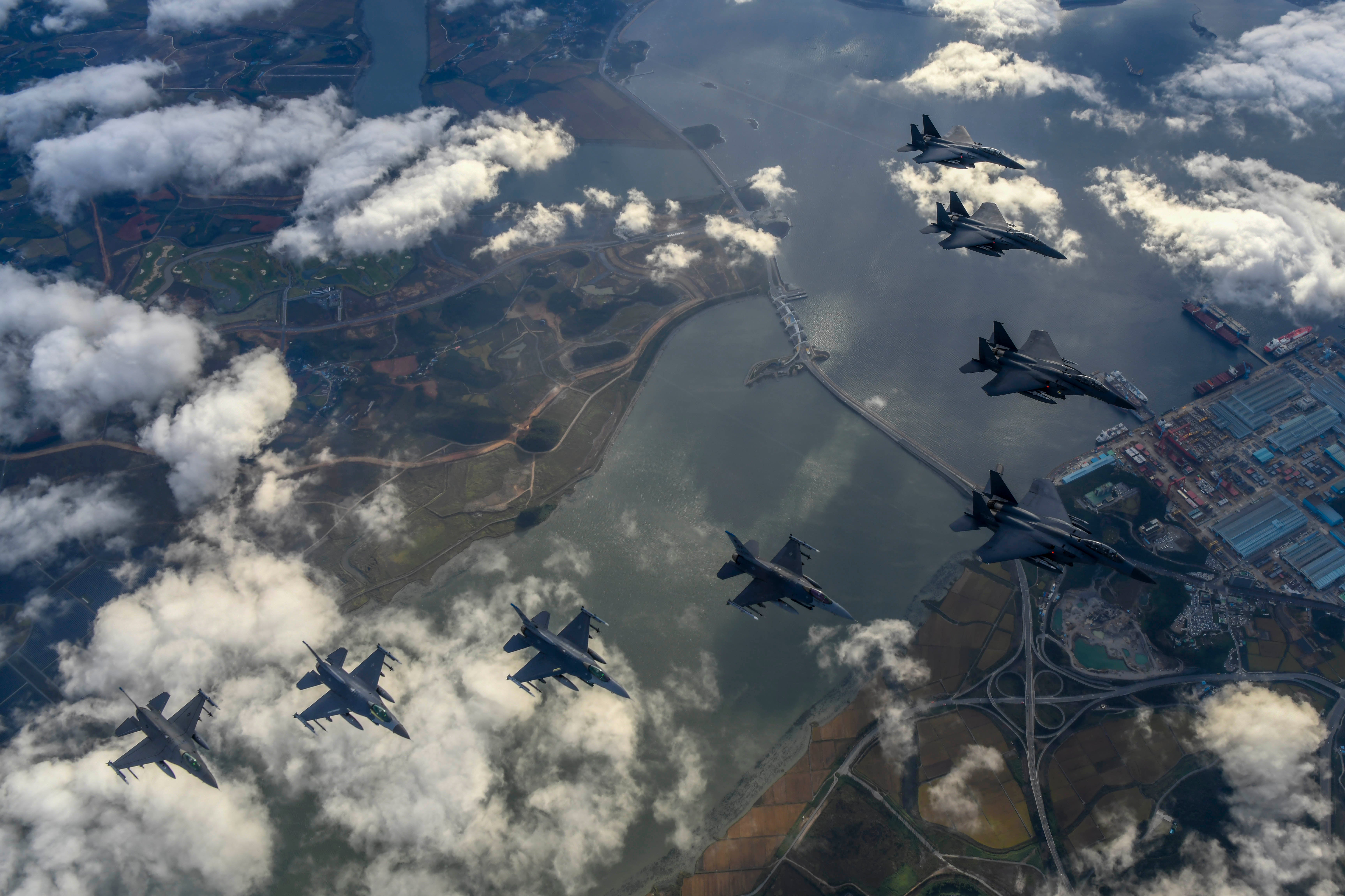 In this handout image released by the South Korean Defense Ministry, South Korean Air Force F-15Ks and US Air Force F-16 fighter jets fly over the Korean Peninsula in response to North Korea’s intermediate-range ballistic missile (IRBM) launch at an undisclosed location