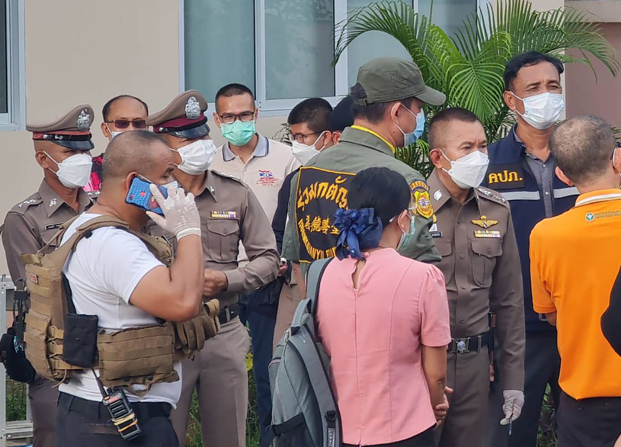 Thai police officers inspect the scene of the massacre