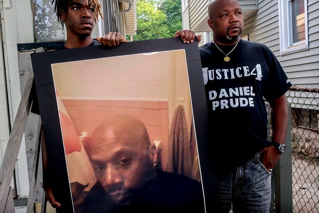<p>Armin Prude, left, and Joe Prude hold an enlarged photo of Daniel Prude, Sept. 3, 2020, who died following a police encounter, in Rochester, N.Y. </p>
