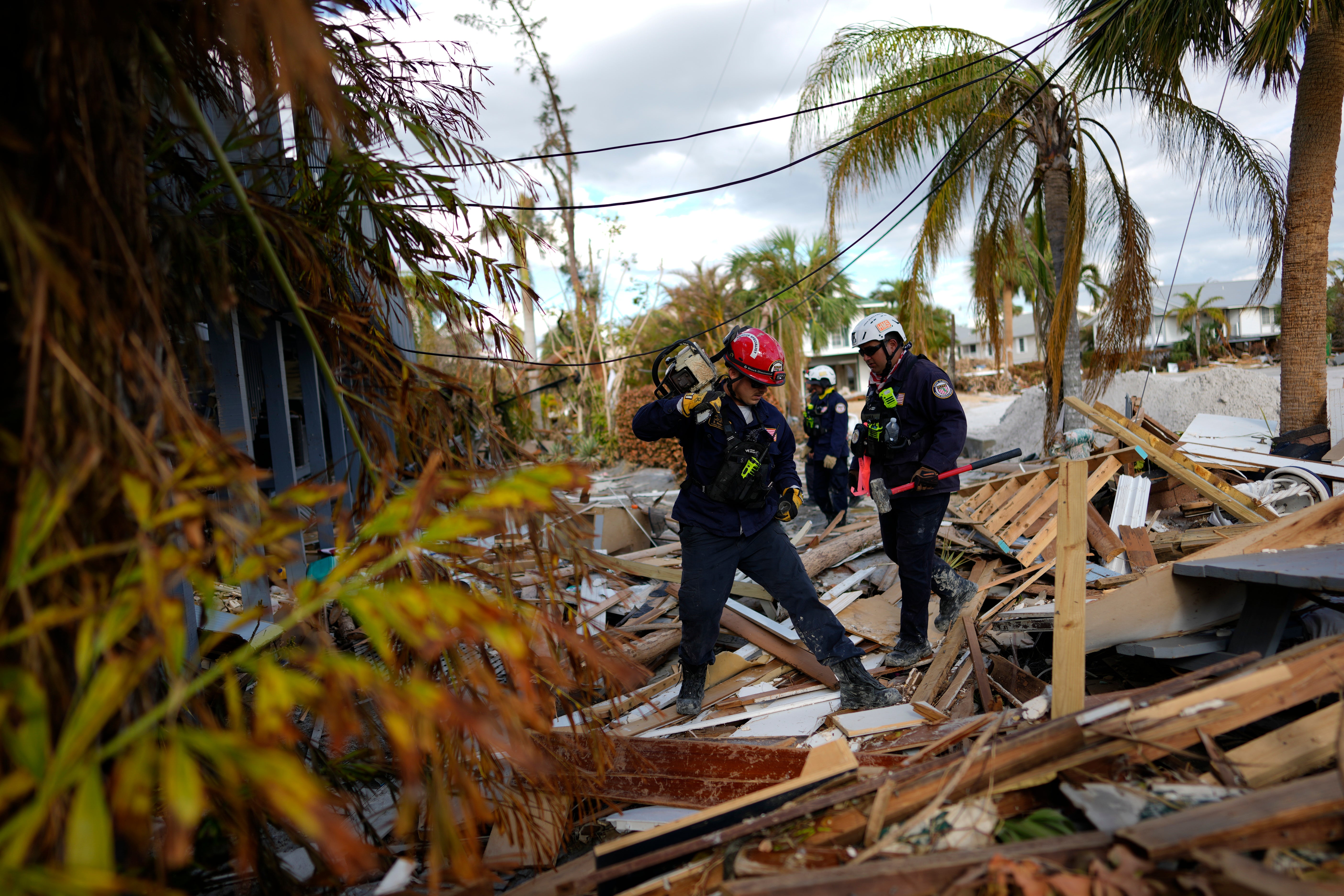 A rescue worker checks debris for people or human remains on Wednesday in Fort Myers Beach, Florida