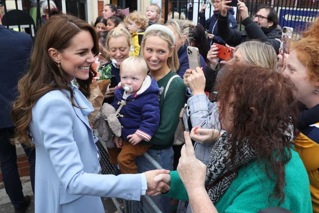 The Princess of Wales was challenged by a woman, wearing a green coat and black and white scarf, as she shook hands on a visit to north Belfast (Liam McBurney/PA)