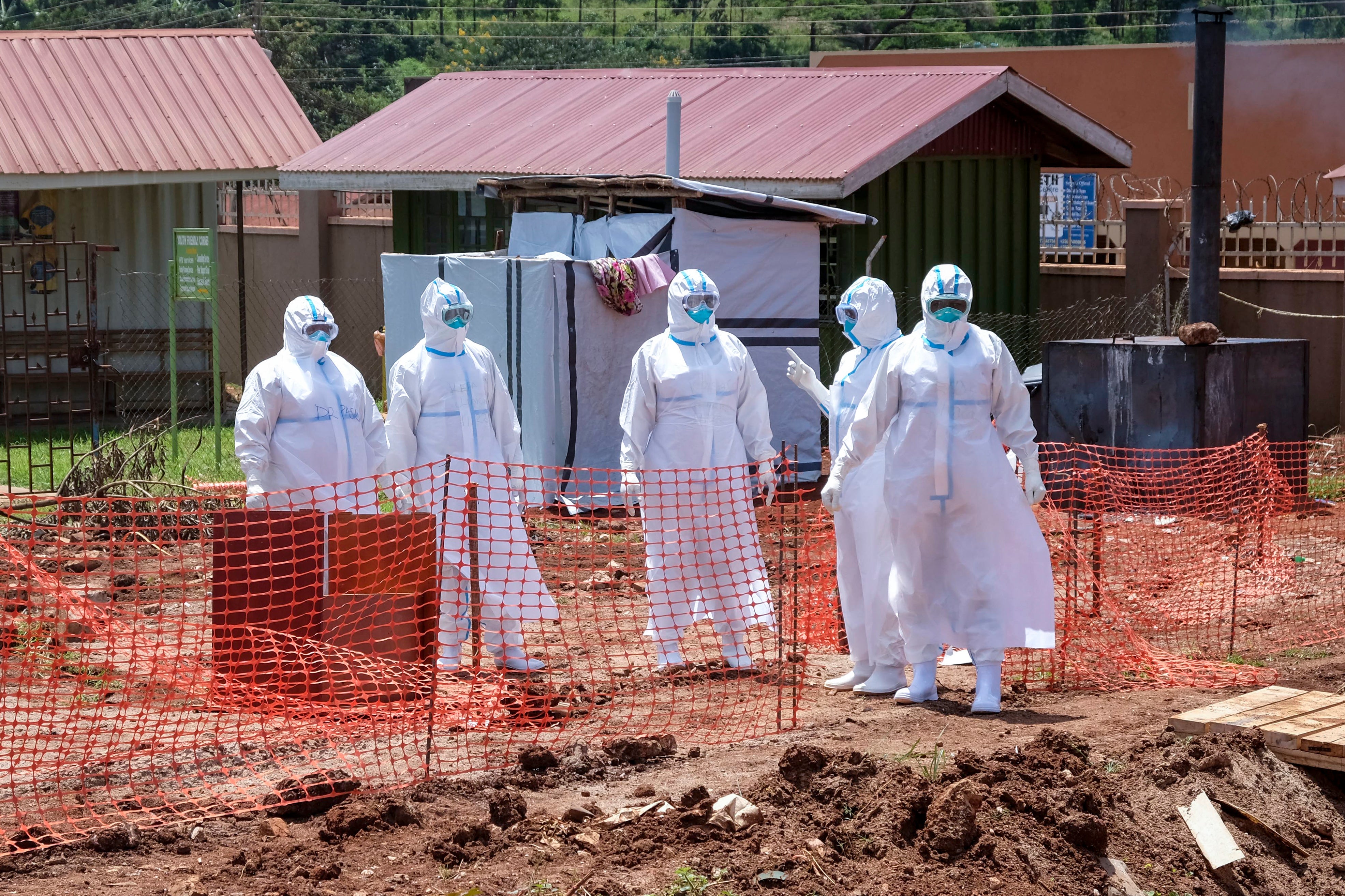 Doctors walk inside the Ebola isolation section of Mubende Regional Referral Hospital, in Mubende, Uganda