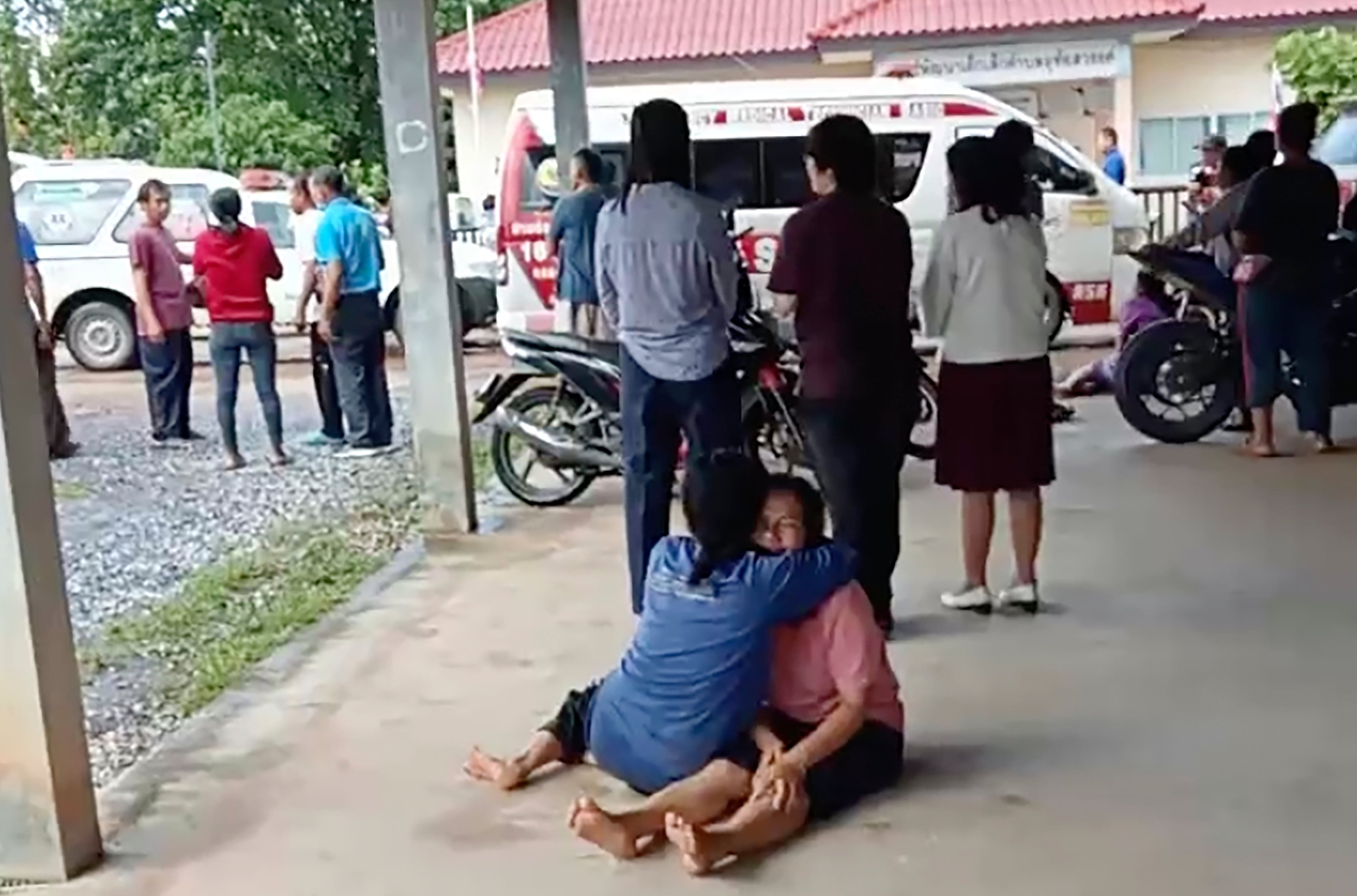 In an image taken from video, a distraught woman is comforted outside the site of the attack