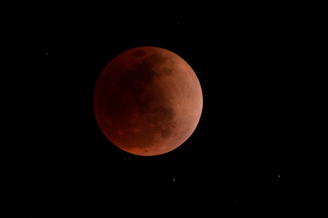 <p>The blood moon is seen during a total lunar eclipse in Canta, east of Lima on May 15, 2022. (Photo by ERNESTO BENAVIDES / AFP) (Photo by ERNESTO BENAVIDES/AFP via Getty Images)</p>
