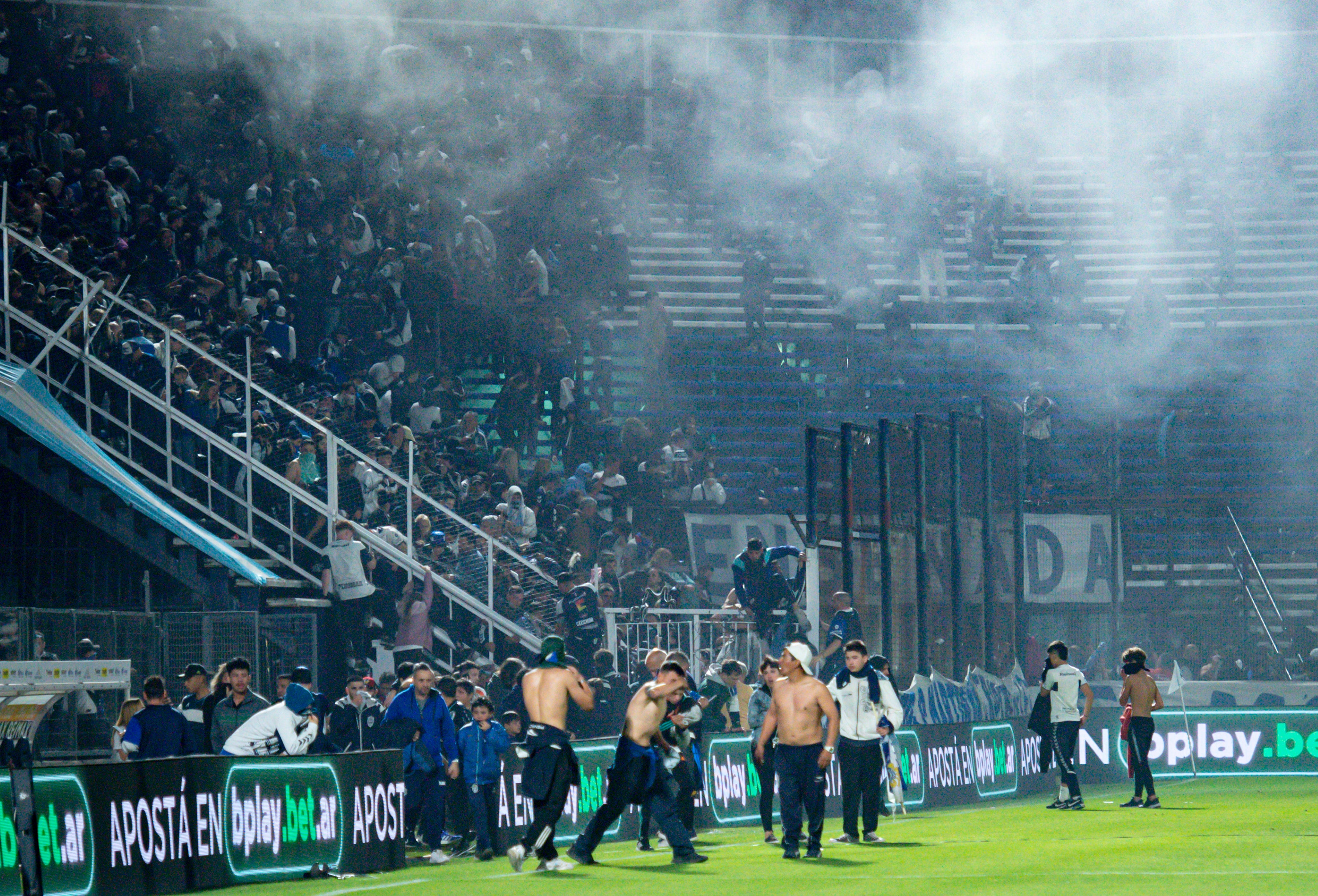 Fans at the Juan Carmelo Zerillo Stadium were forced on to the pitch after tear gas drifted in to the stands