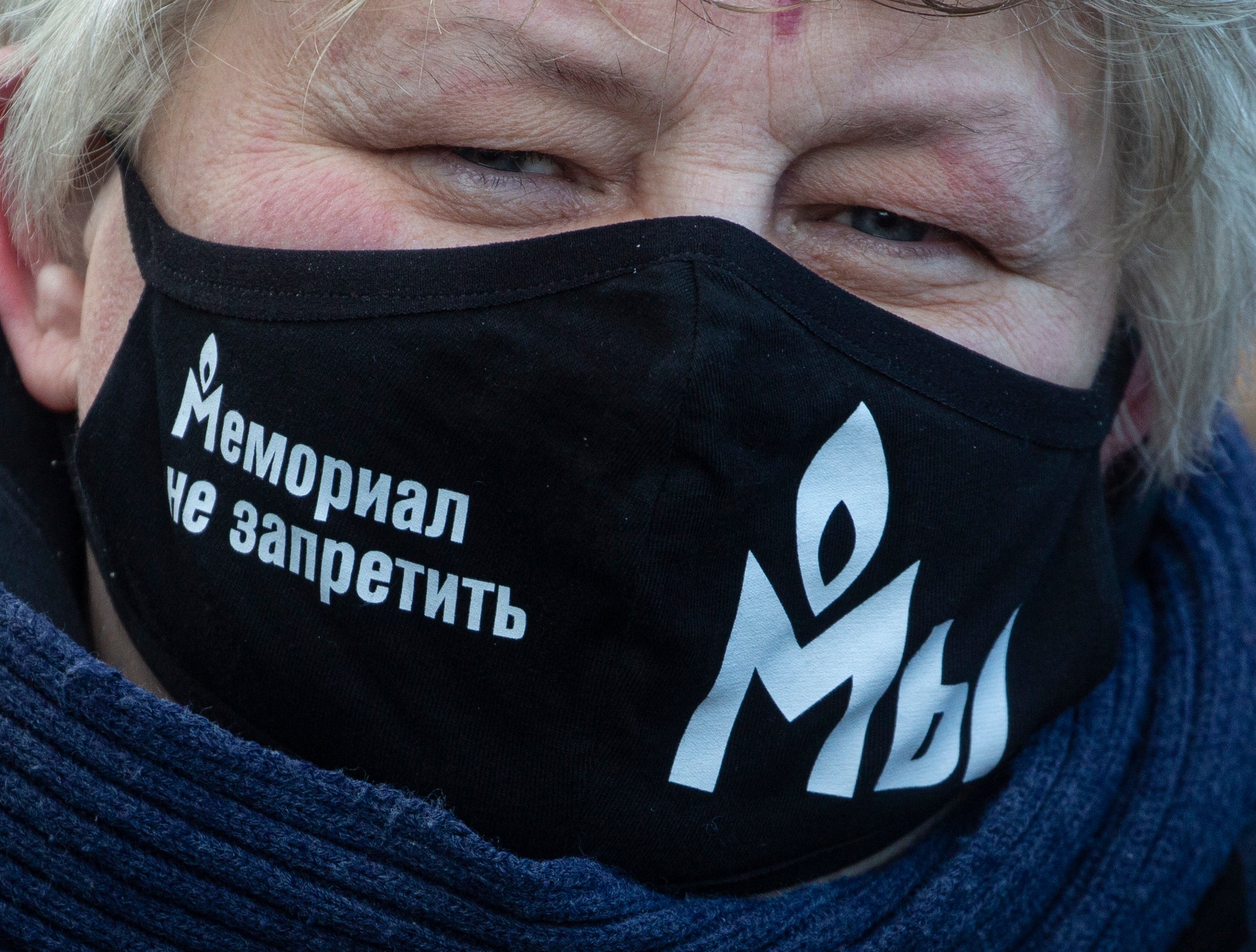 A supporter of the human rights group ‘Memorial’ wears a face mask reading ‘Memorial is not banned’ while gathering for a preliminary court hearing last year