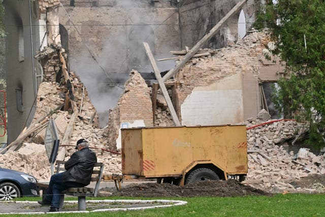<p>A resident sits outside a building allegedly destroyed by Iranian-made drones after a Russian airstrike on Bila Tserkva, southwest of Kyiv</p>