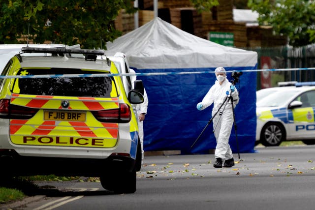 <p>Police forensic officers at Ascot Drive police station in Derby</p>