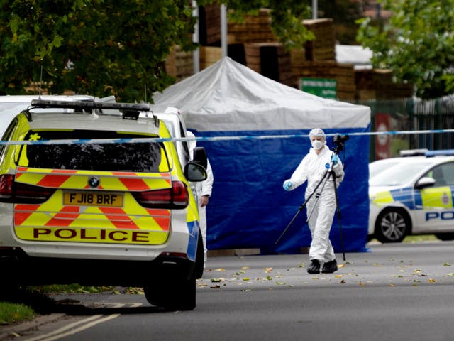 <p>Police forensic officers at Ascot Drive police station in Derby</p>