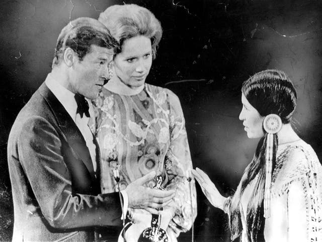 <p>Roger Moore and Liv Ullmann look nonplussed as Sacheen Littlefeather declines the Best Actor Oscar on behalf of Marlon Brando in 1973 </p>