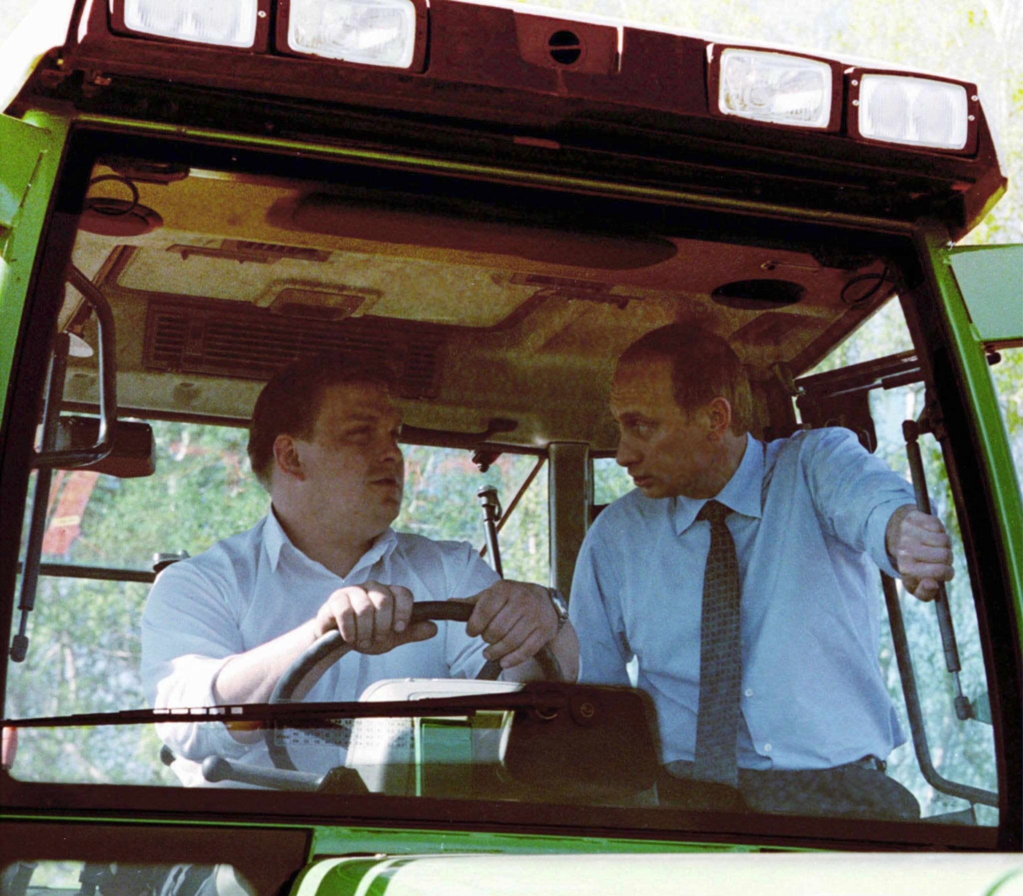 Vladimir Putin sits in a tractor while visiting the Russian village of Baklanovo in April 2000