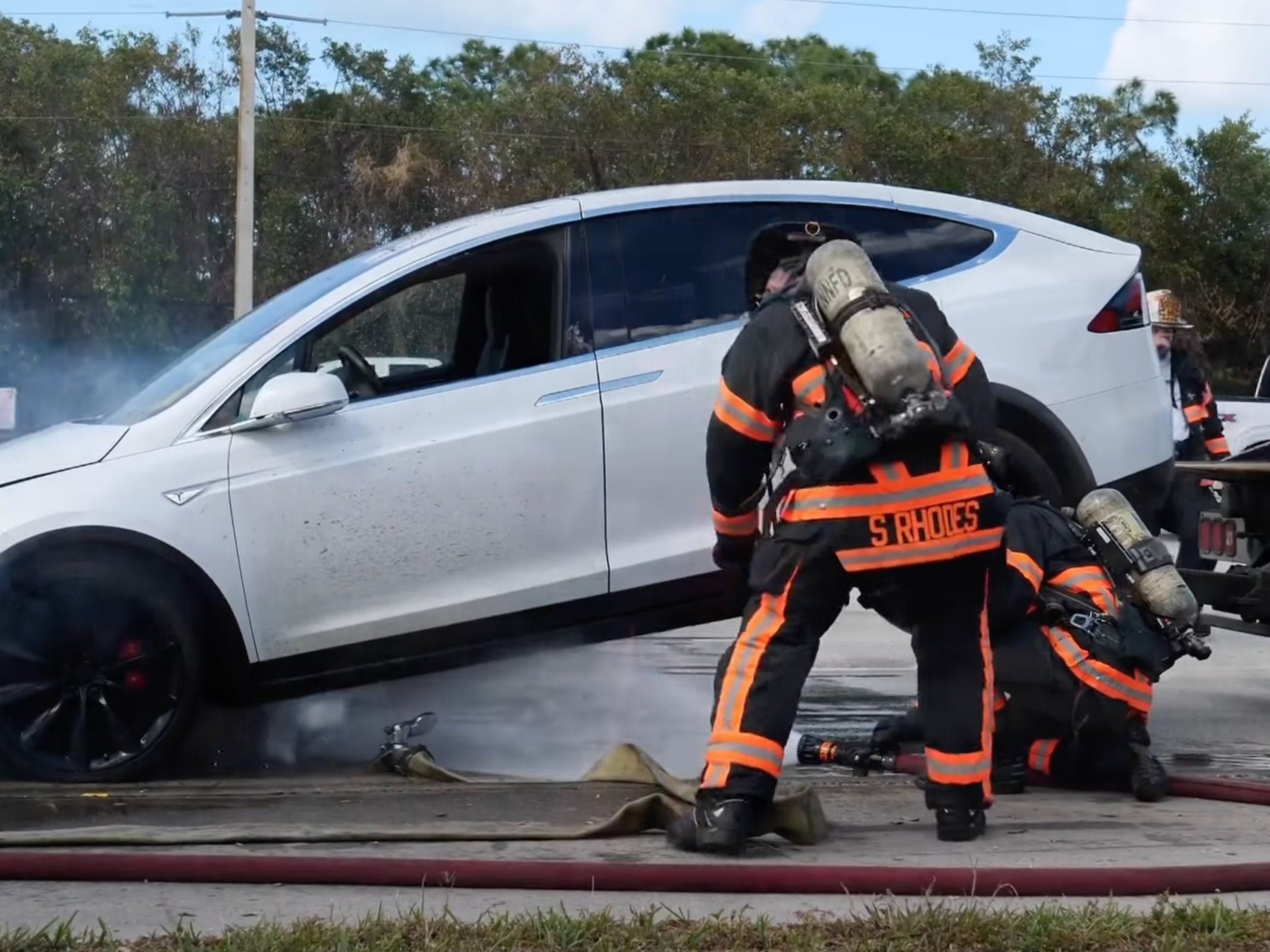 Firefighters in Florida attempt to put out a Tesla fire prompted by Hurricane Ian