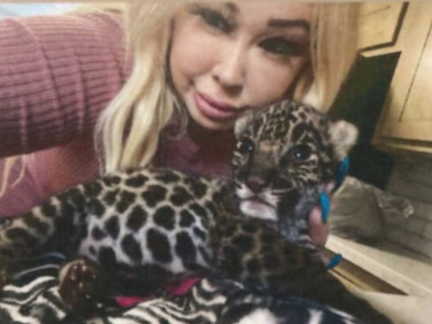 A screenshot of a social media post showing Trisha Denise Meyer, 40, holding a jaguar cub, which she is accused of selling off for $30,000