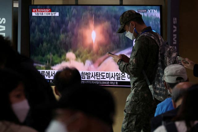 <p>A South Korean soldiers walks past a TV broadcasting a news report on North Korea firing a ballistic missile</p>
