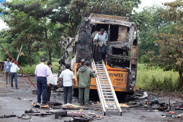 <p>People inspect a bus that caught fire in a highway near Nashik, Maharashtra</p>