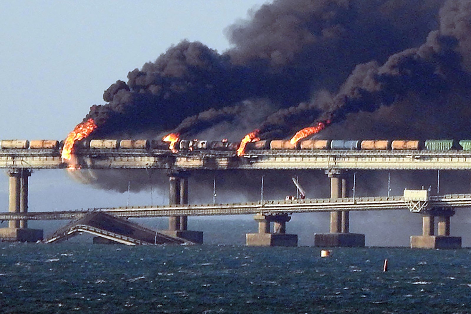 Thick smoke rising from parts of the Kerch Strait bridge on Saturday