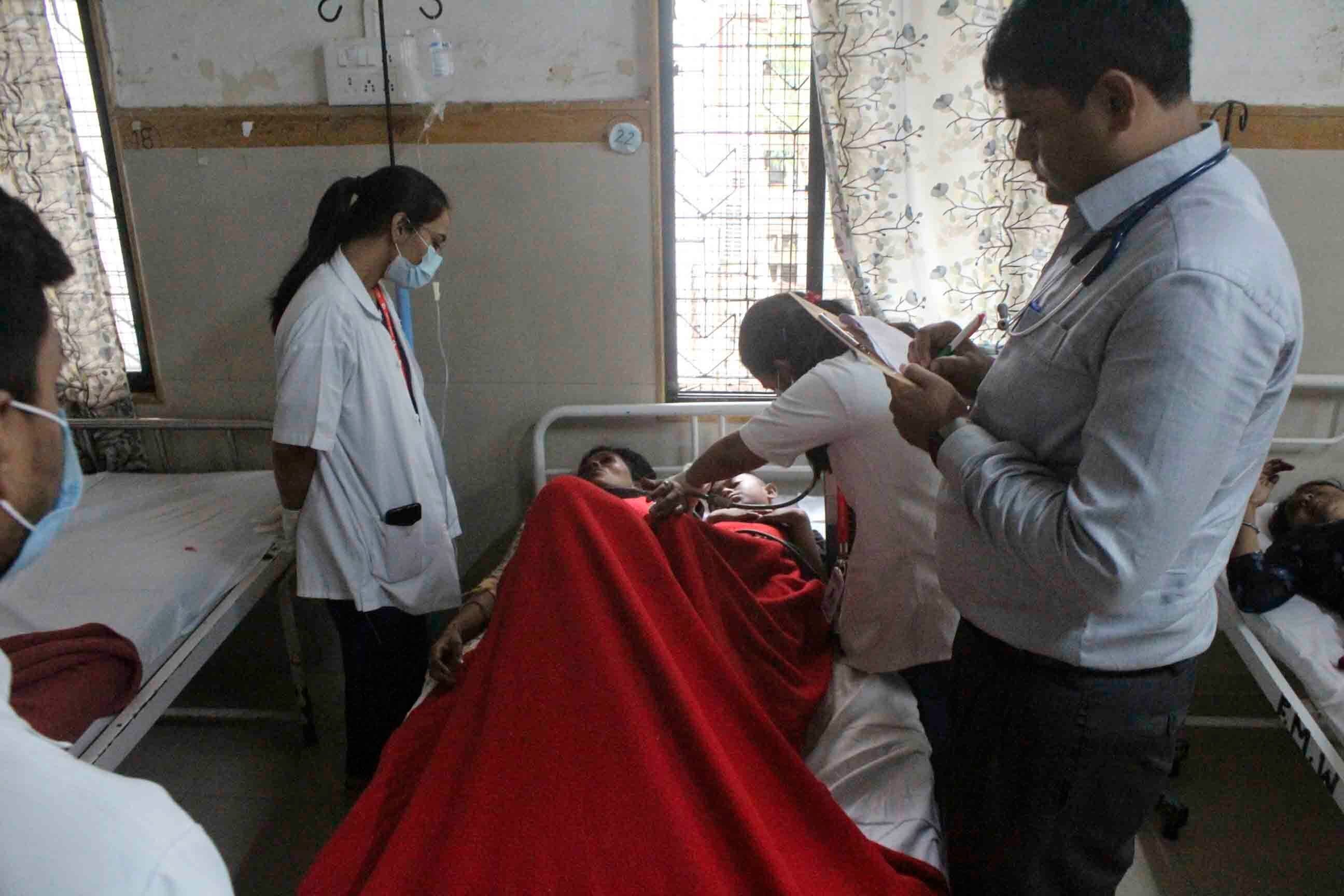 Medics treat people injured in a bus that caught fire in a highway in Nashik