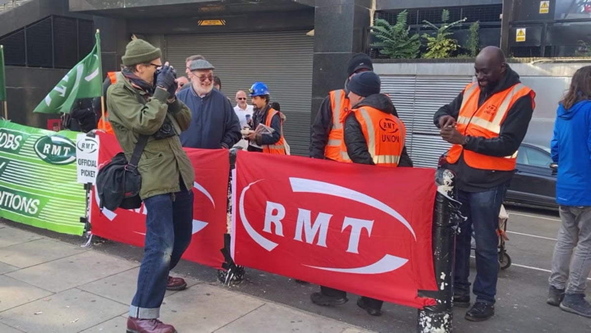 Members of RMT union strike outside Euston station as trains disrupted across UK
