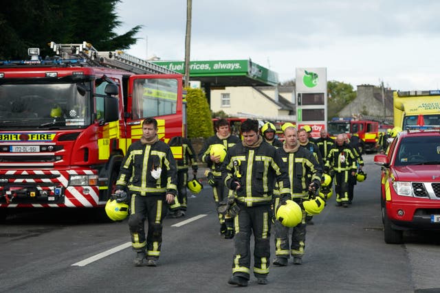 Firefighters leave the scene of an explosion at Applegreen service station in the village of Creeslough in Co Donegal (Brian Lawless/PA)