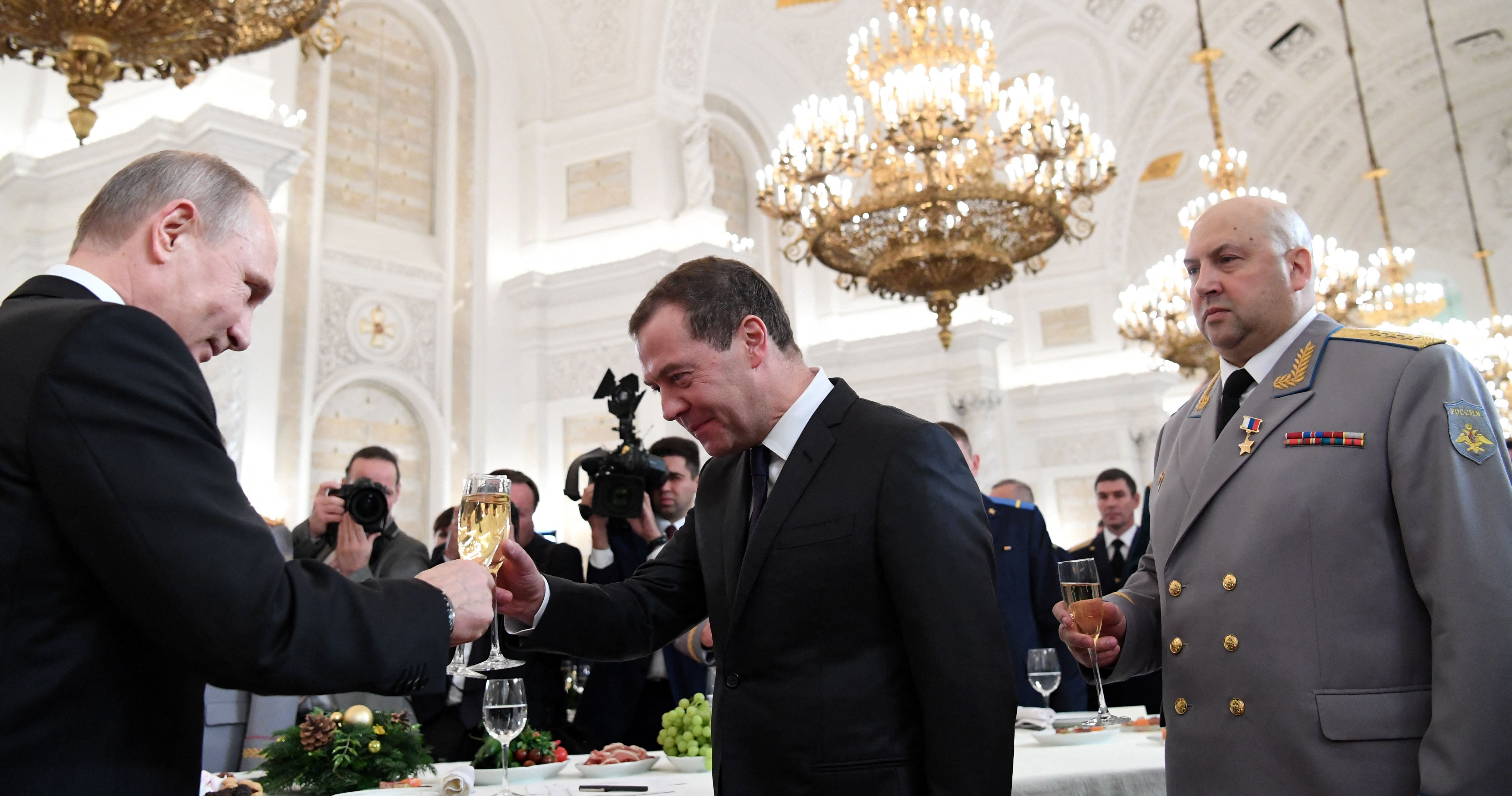 Sergei Surovikin watches on as Vladimir Putin toasts then prime minister Dmitry Medvedev