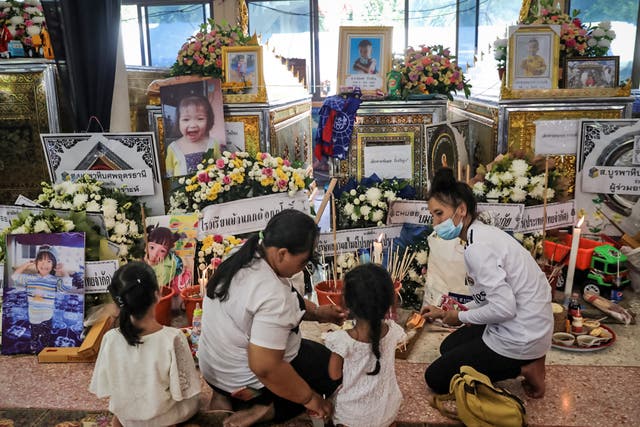 <p>Relatives of victims gather at the Wat Rak Samakee temple</p>
