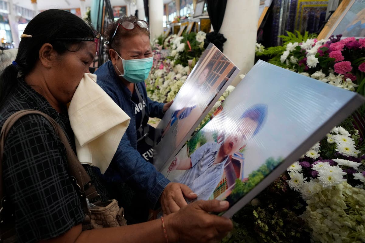 Grieving families pray at Thai temple for slain victims