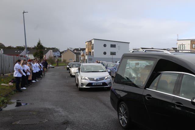 Staff from Letterkenny hospital pay their respects as the coffin of James O’Flaherty, who died in the explosion at Applegreen service station in the village of Creeslough in Co Donegal on Friday, is removed from the Eternal Light Chapel of Rest in Letterkenny (Liam McBurney/PA)