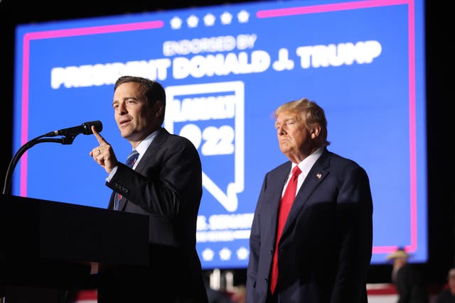 <p>Adam Laxalt, with former President Donald Trump looking on </p>