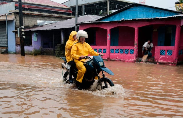 <p>People ride a motorbike through flooded streets in Bluefields, Nicaragua on Sunday</p>