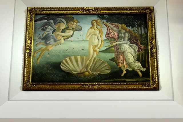 <p>A visitor walks by "The birth of Venus" painted in the mid 1480s by Italian painter Sandro Botticelli during a press preview for the reopening of the rooms dedicated to Pollaiolo and Botticelli, at the Uffizi Gallery in Florence, on October 17, 2016</p>