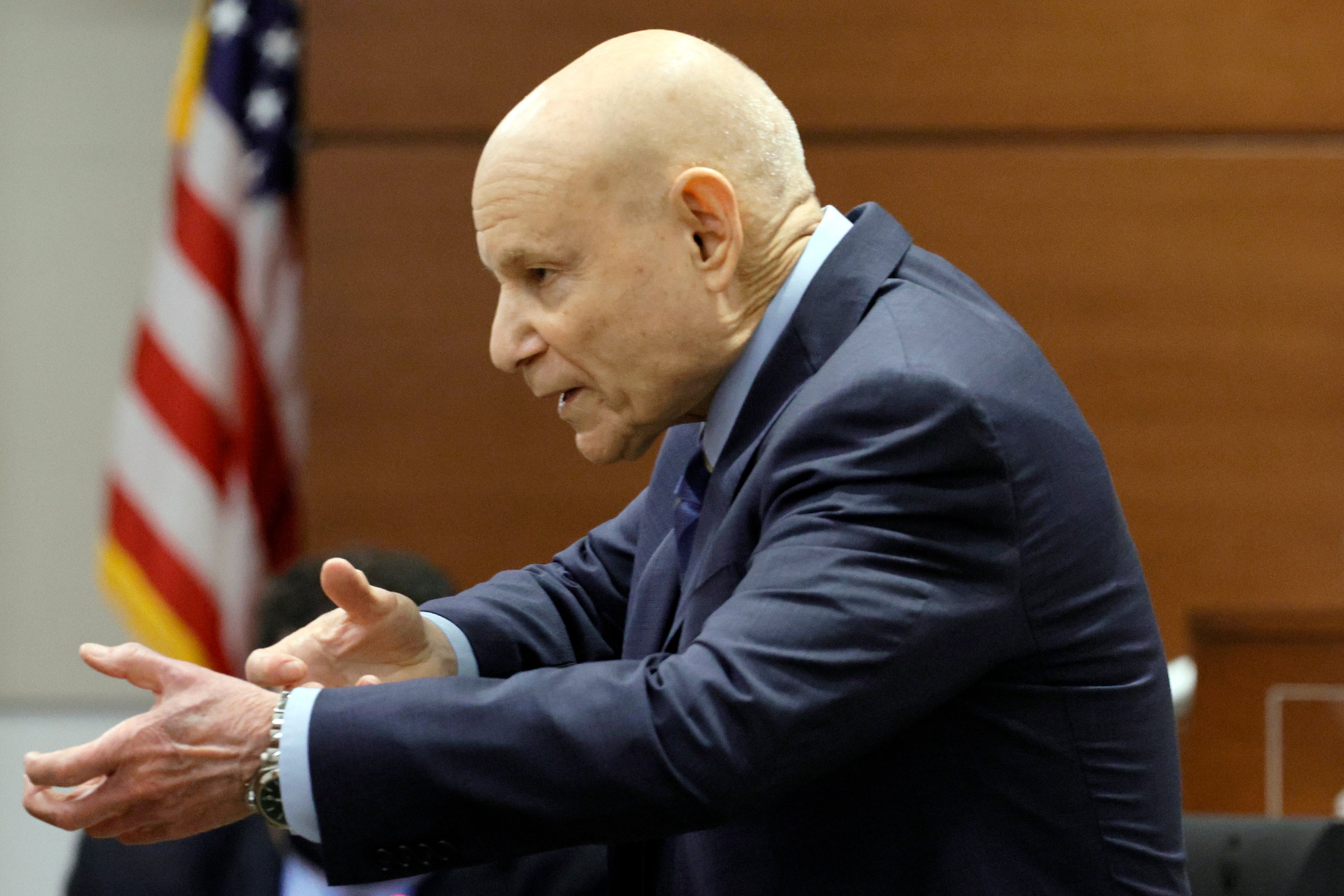 Prosecutor Mike Satz gestures as if he is holding a rifle during his closing argument