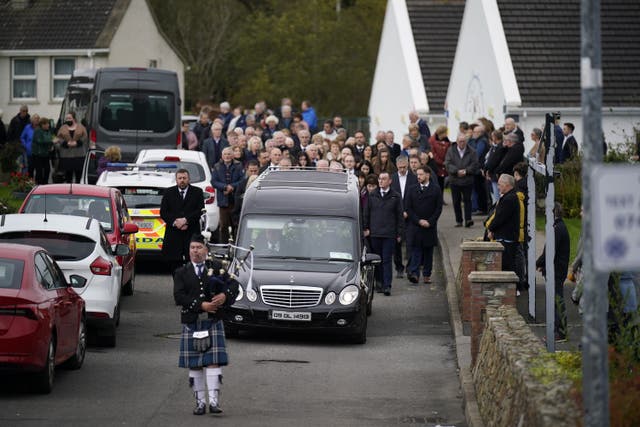A piper plays as the hearse carrying Martin McGill, 49, arrives at St Michael’s Church, Creeslough, for his funeral mass (Niall Carson/PA)