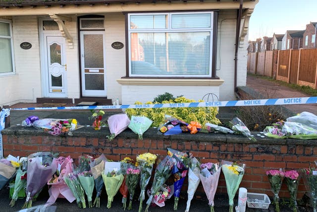 Flowers outside a house on Station Road, Langwith Junction, Shirebrook, near Bolsover, where Kenneth Walker 86, was found with life-threatening injuries alongside his wife Freda Walker 88, who was pronounced dead at the scene (PA)