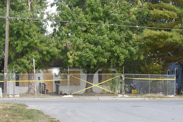 <p>Police tape blocks off the residence of Timothy M Haslett Jr, after the home was boarded up and fenced off Monday, 10 October 2022, in Missouri’s Excelsior Springs city </p>