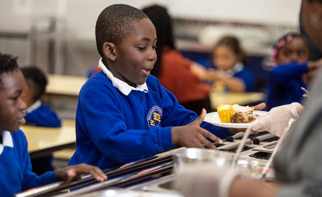 <p>Mandeville Primary in east London serves free meals to all pupils but the situation differs at other schools</p>