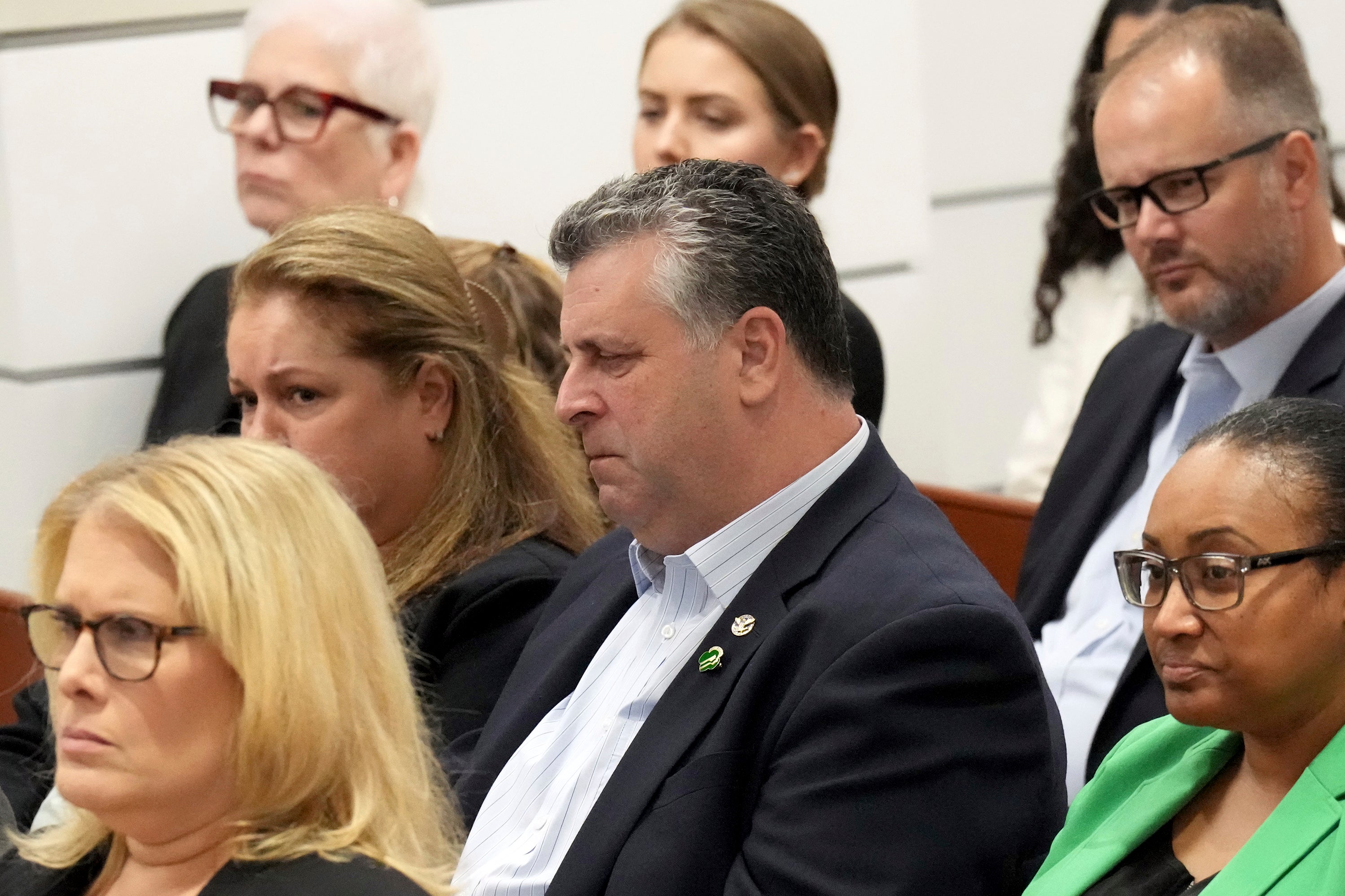 Tony Montalto, seated with his wife, Jennifer Montalto, closes his eyes as Assistant State Attorney Mike Satz details the murders of the victims including his daughter Gina