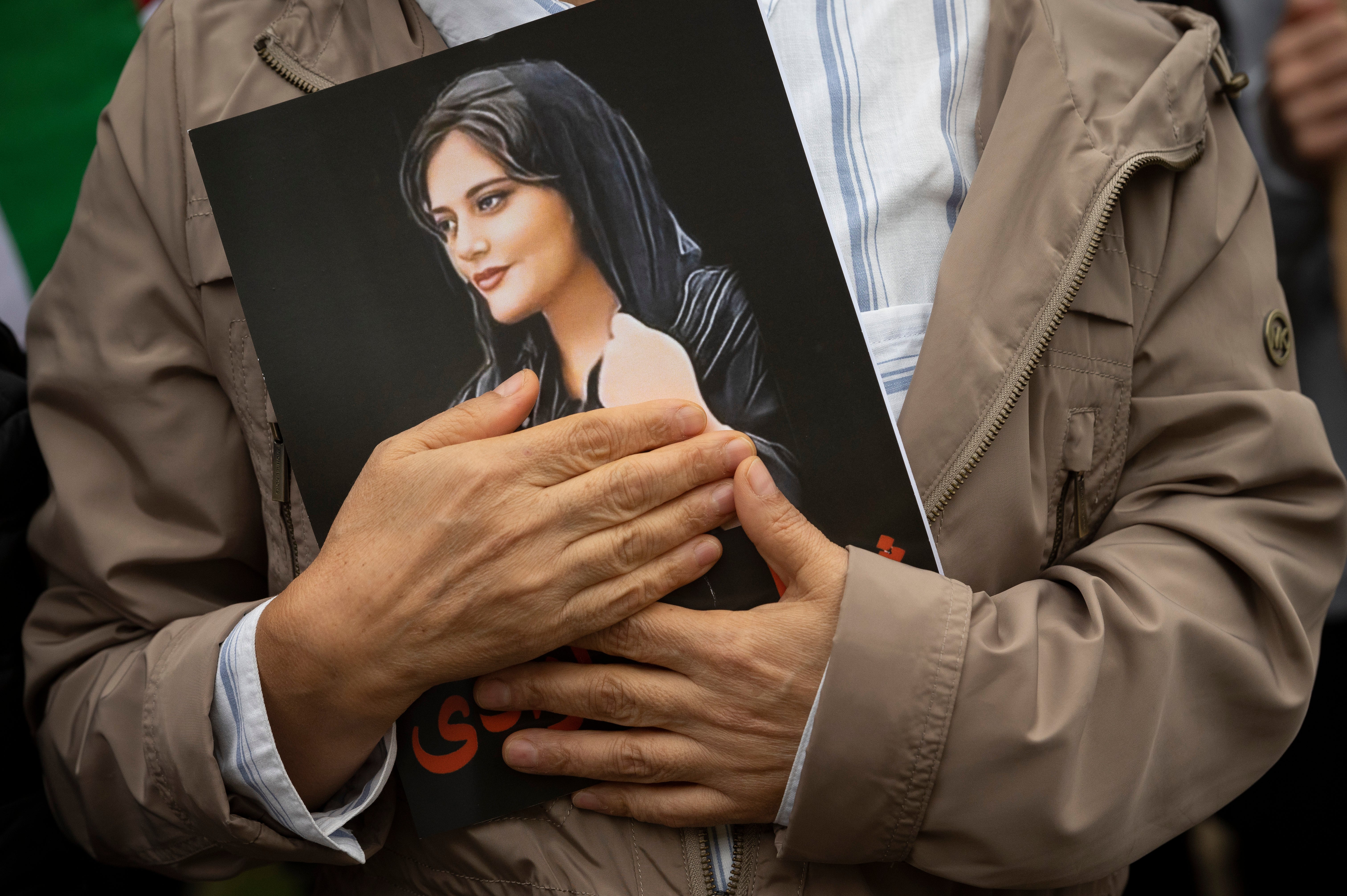 A portrait of Mahsa Amini is held during a rally calling for regime change in Iran