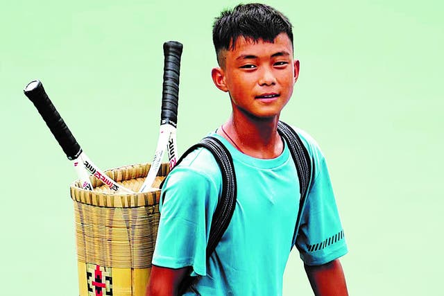 <p>Wang Fa carries his rackets in a bamboo basket at the ASICS Tennis Junior Tour</p>