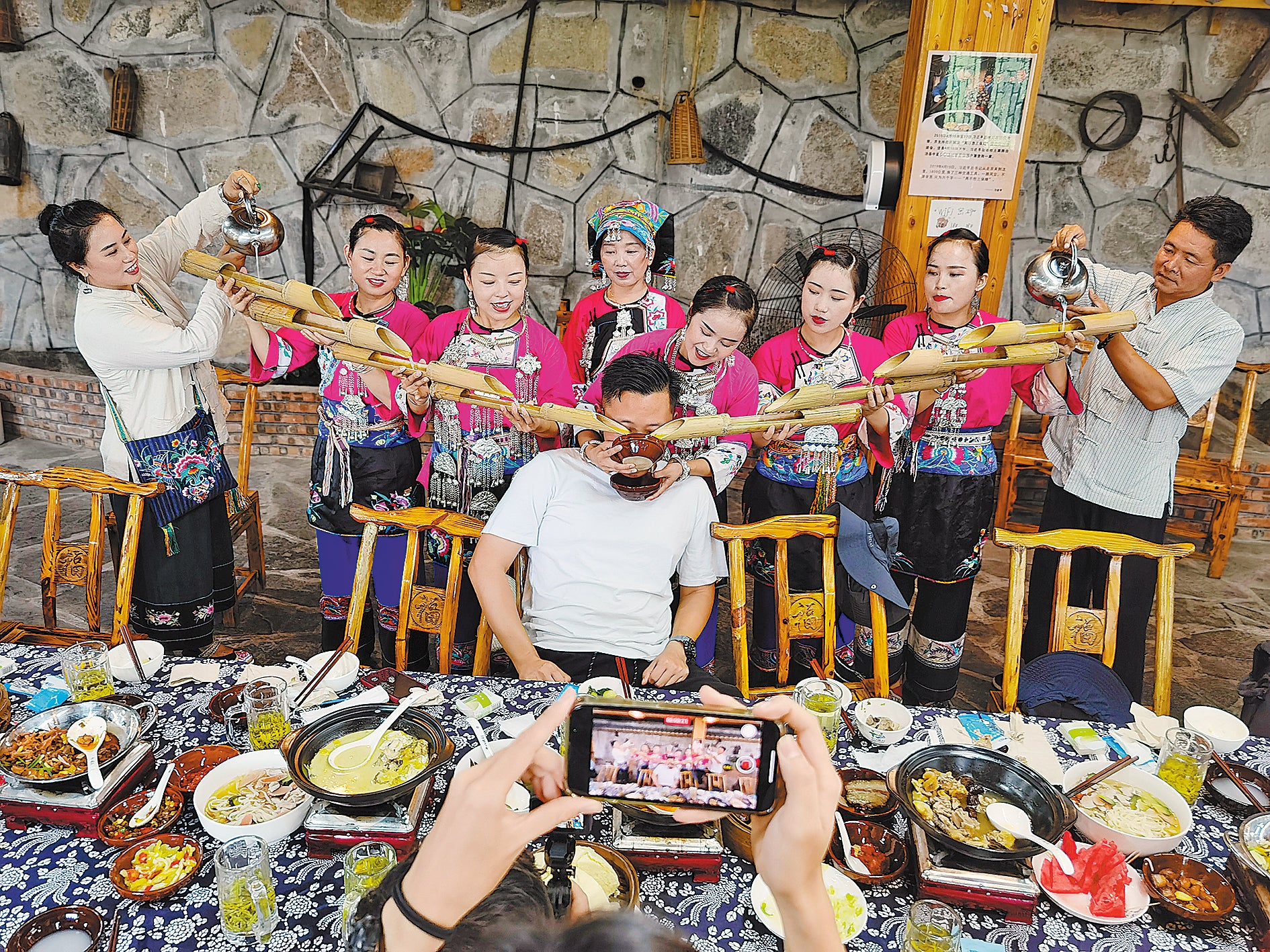 Villagers welcome a guest by cascading liquor down chutes made of bamboo in Shibadong village, Hunan province