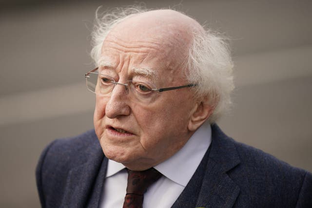 Irish President Michael D. Higgins leaves the funeral mass for James O’Flaherty at St Mary’s Church, Derrybeg (Niall Carson/PA)