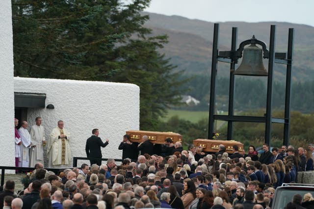 The coffins of James Monaghan and his mother Catherine O’Donnell are carried into St Michael’s Church. (Brian Lawless/PA)