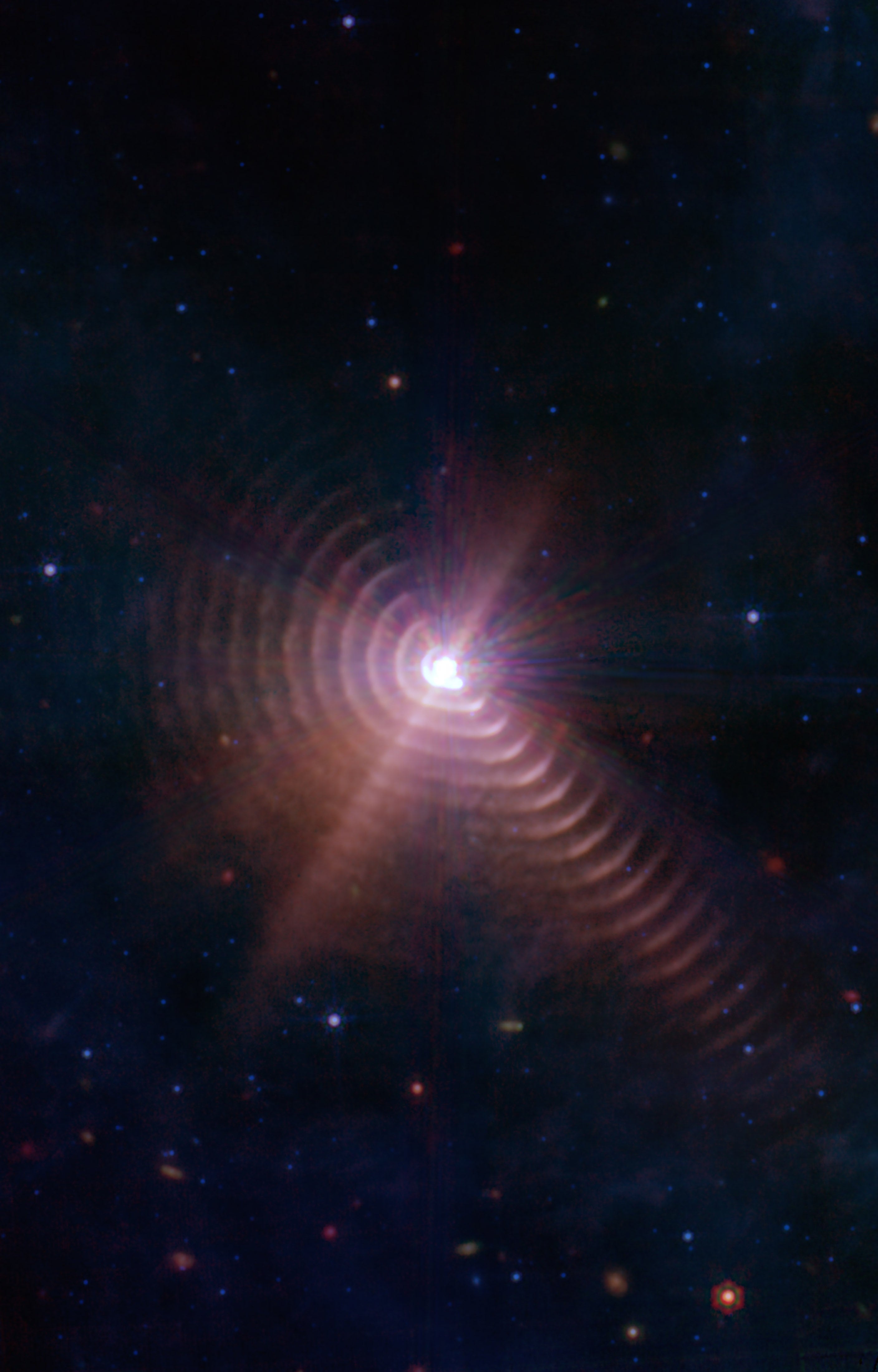 Rings of dust are blown away from the binary star WR140, pushed across the cosmos by powerful solar wind