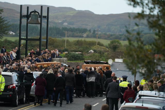 The coffins of James Monaghan and his mother Catherine O’Donnell are carried into St Michael’s Church, Creeslough (Brian Lawless/PA)