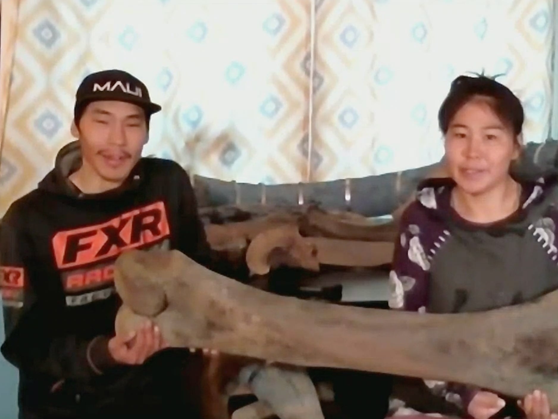 Joseph and Andrea Nassuk of Elim, Alaska with the mammoth bone they found on a walk