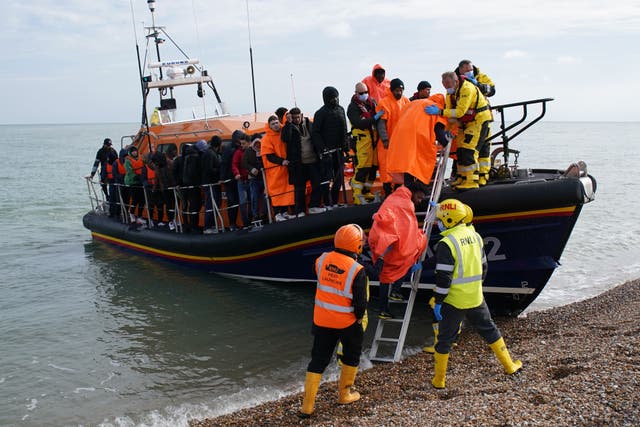 Children wrapped in blankets were carried to safety as Channel crossings continued for the fifth day in a row (Gareth Fuller/PA)