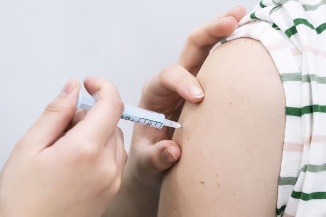 People are being urged to get their flu and Covid-19 jabs (Danny Lawson/PA)