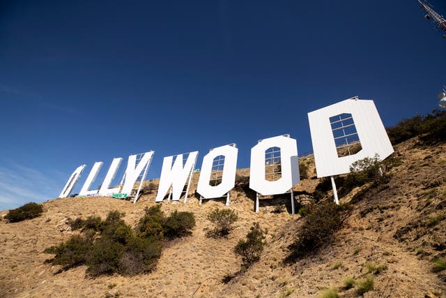 <p>Workers repaint the Hollywood Sign during a restoration of the landmark, in the Hollywood Hills of Los Angeles, California,</p>