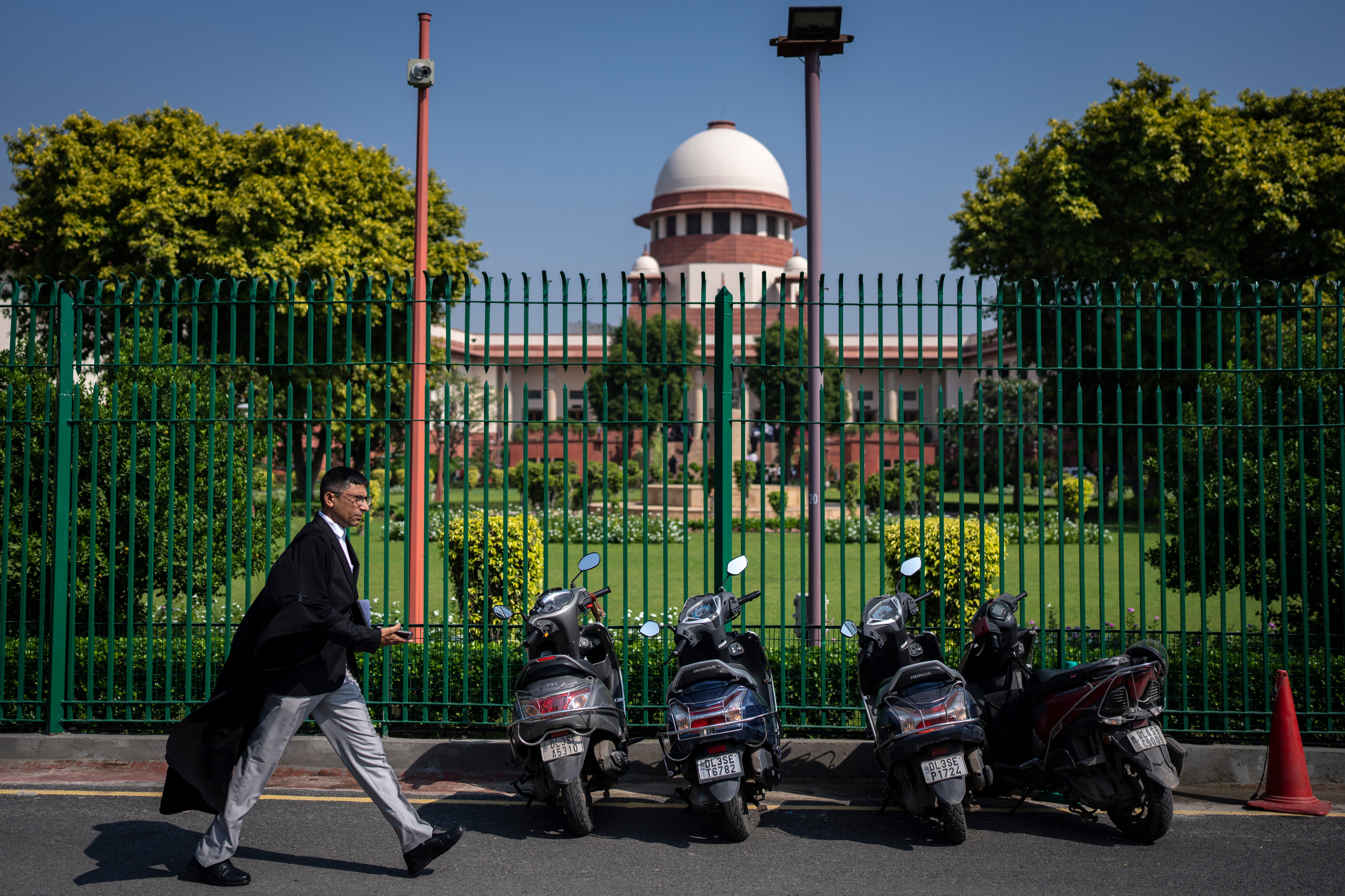 File: A lawyer walks past the Supreme Court of India