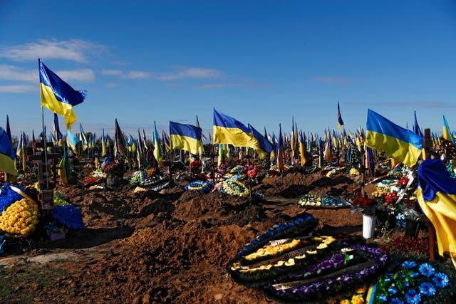 <p>Ukrainian flags are placed at a cemetery of the Kyiv army in Kharkiv</p>